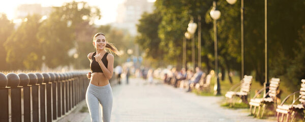 Millennial fitness woman jogging outdoors in park