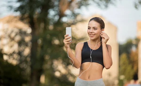 Fitness meisje met selfie en het luisteren naar muziek met oordopjes, — Stockfoto