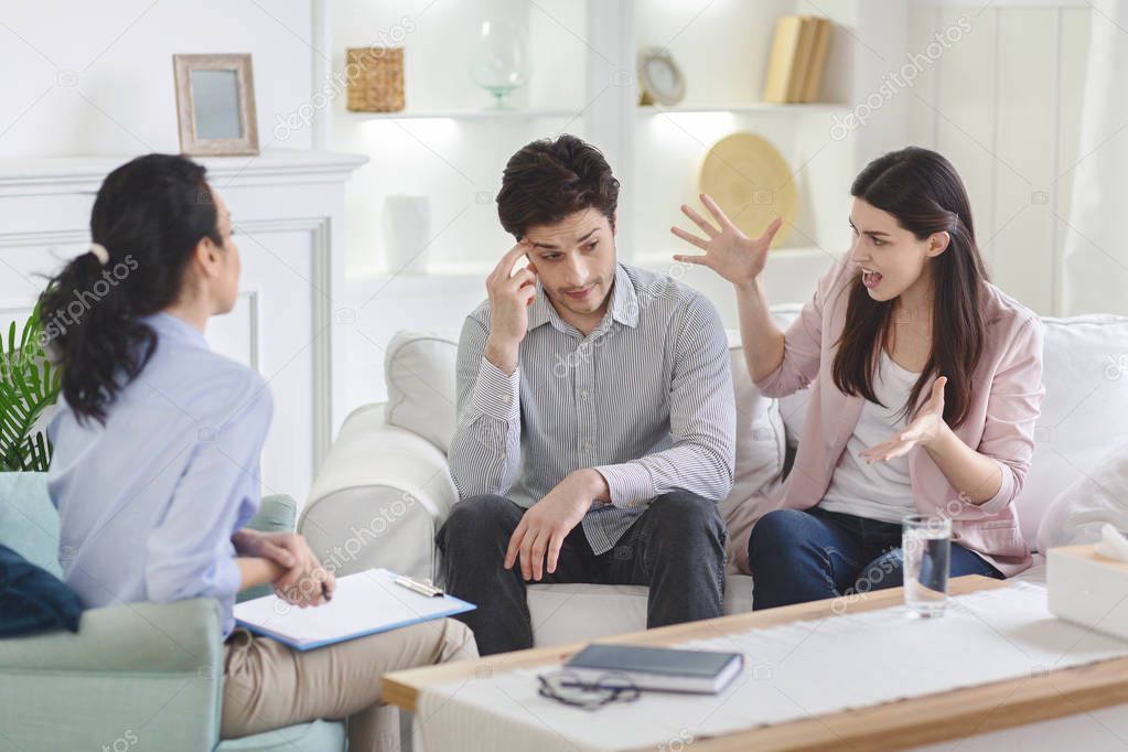 Couple talking with their therapist in office