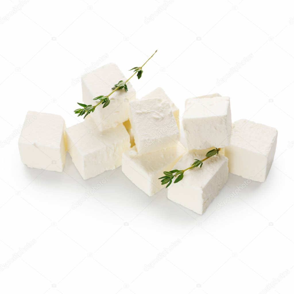 Heap of feta cheese cubes on white