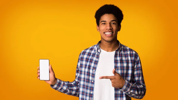 stock image Present new app. Guy pointing at blank screen phone