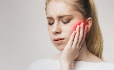 Young womanhaving strong toothache and suffering from pain