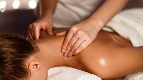 Menina desfrutando de massagem terapêutica no pescoço no spa — Fotografia de Stock