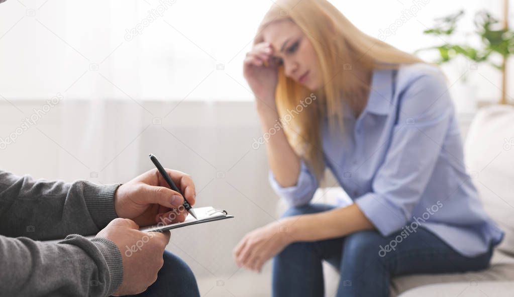 Depressed woman discussing her problems with therapist