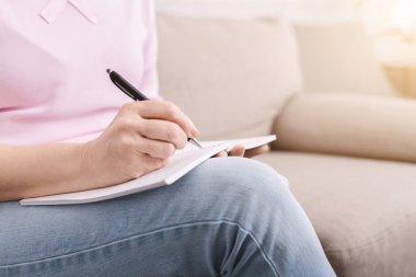 Defterile iyi organize kıdemli kadın, yapılacaklar listesi yazma