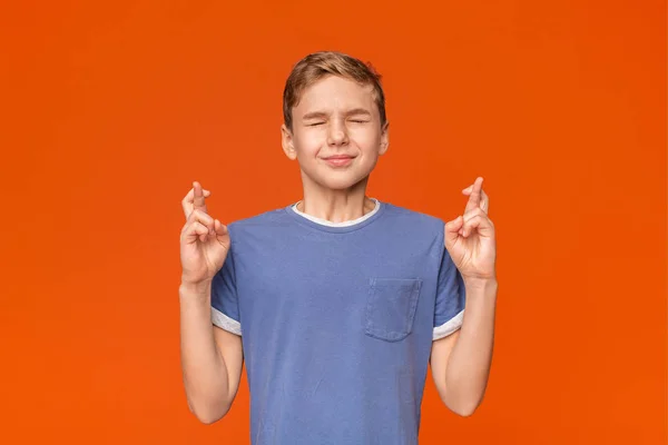 Teenager crossing fingers wishing, praying for miracle — Stock Photo, Image