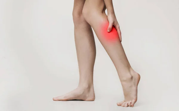 Woman massaging her painful leg calf, close up — Stock Image Woman massaging her painful leg calf, close up Royalty Free Stock Images