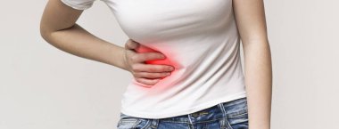 Woman in pain holding her stomach on right side clipart
