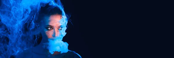 Mysterious Woman Smoking Electronic Cigarette in neon color light — Stock Photo, Image