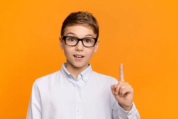 Smart boy pointing finger up, having idea or found solution — Stock Photo, Image