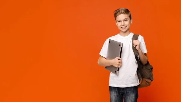 Vriendelijke school jongen Holding laptop, naar school gaan met computer — Stockfoto