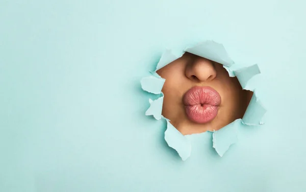 Woman Sharing Kiss Through Torn Blue Paper — Stock Photo, Image