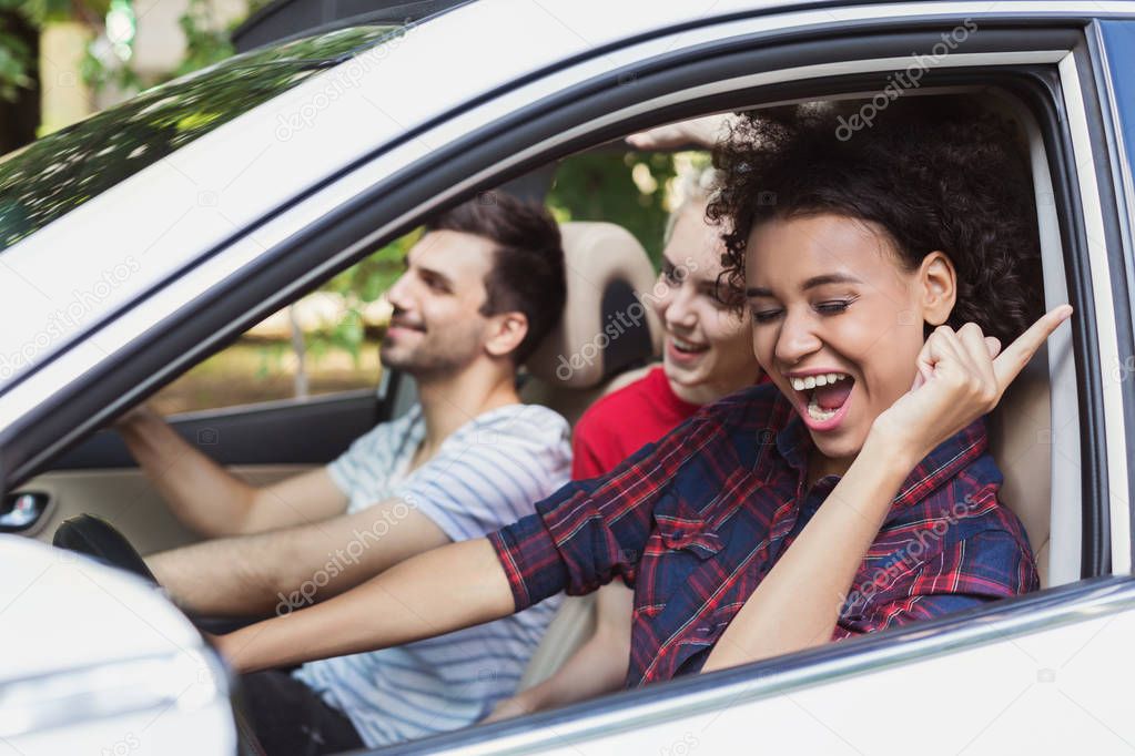 Happy friends in car