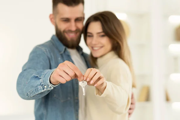 New Home Owners. Young Couple Holding House Key