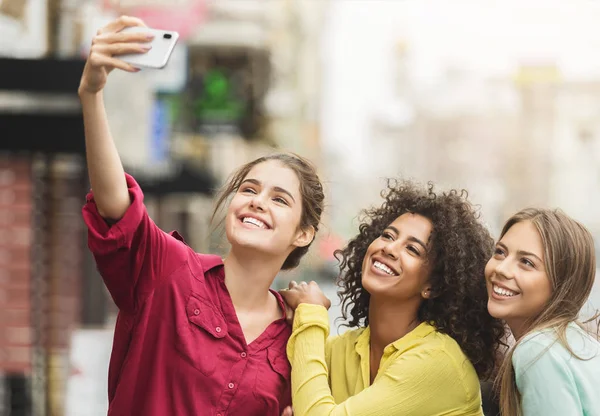 Lyckliga vänner gå i staden och ta Selfie — Stockfoto