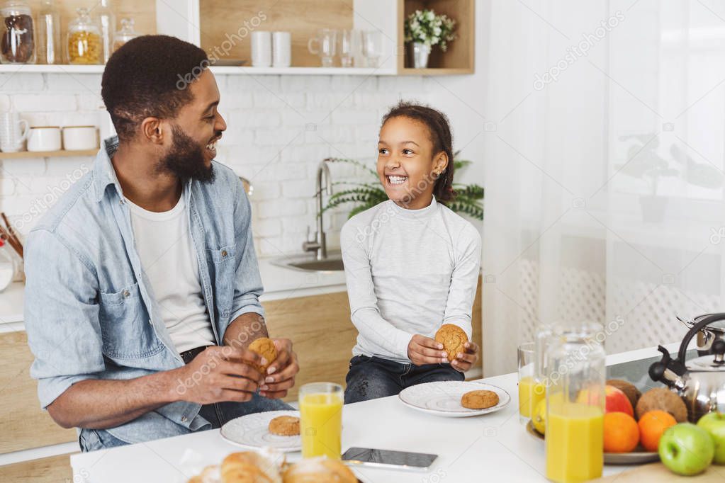 afro child girl and her father having breakfast