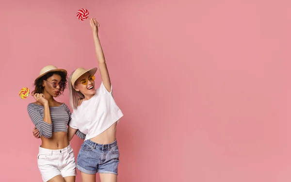 Cheerful Diverse Girls With Lollipops Looking at Empty Space