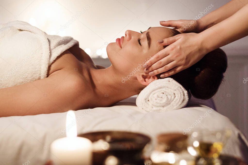 Aromatherapy. Woman Enjoying Face Massage In Spa
