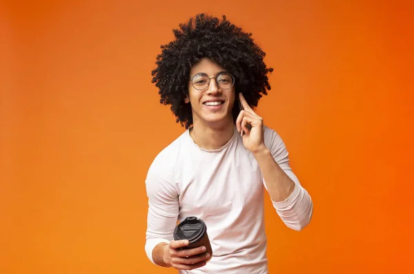 Glad afrikansk amerikansk kille pratar på telefon med kaffe-to-go — Stockfoto