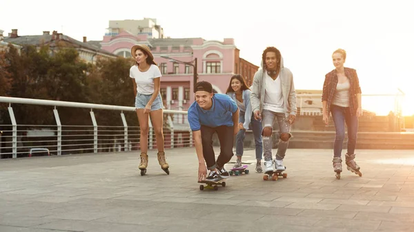 Rozmanitá mládež jízda na Skateboarcích a válcích — Stock fotografie