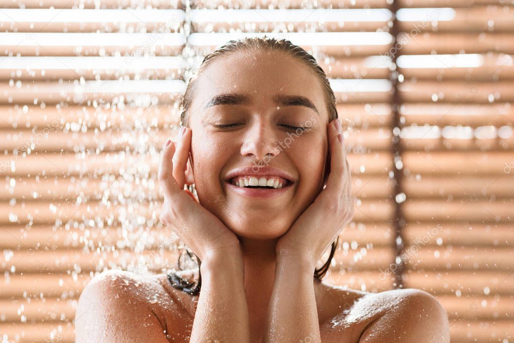 Woman Enjoying Cool Shower Under Water Jet