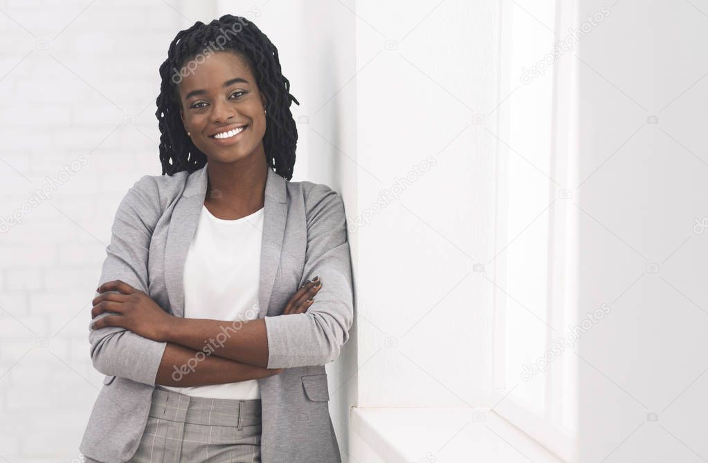 Afro Businesswoman Standing Near Window In Office