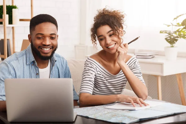 Afro Couple Booking Tour For Honeymoon On Laptop