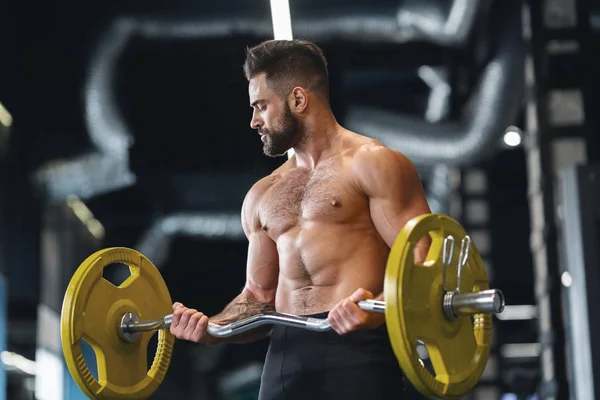 Handsome naked weightlifter lifting heavy barbell in gym — Stock Photo, Image