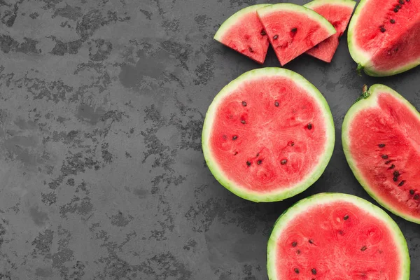 Cut fresh juicy watermelon on dark grey table — Stock Photo, Image