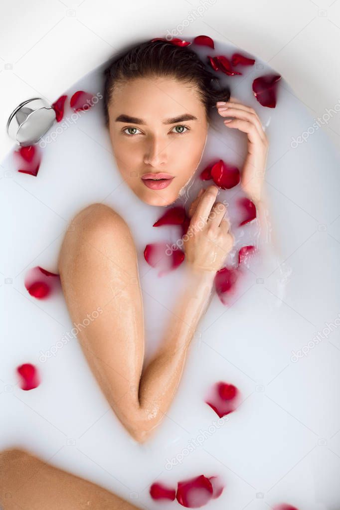 Naked Girl Enjoying Milk Bath With Rose Petals
