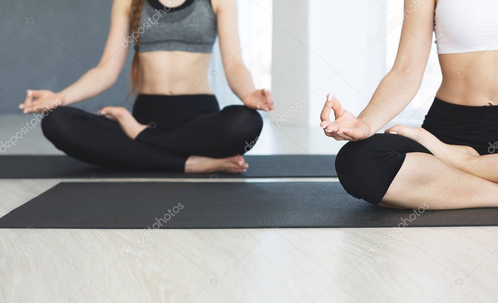 Female meditation in lotus pose in yoga class