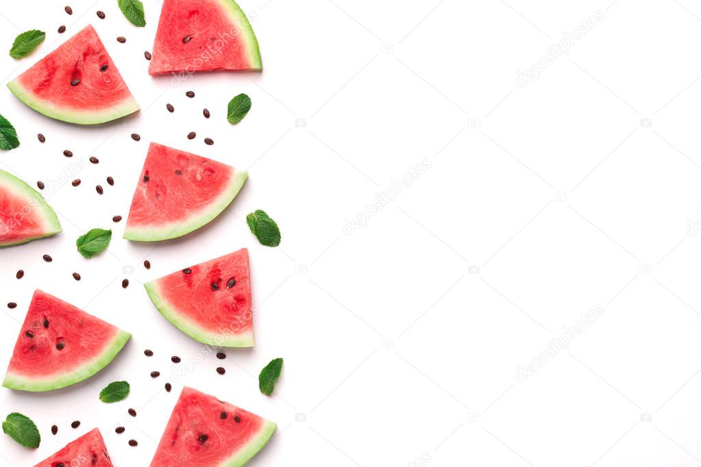 Fresh watermelon slices with seeds and leaves on white background