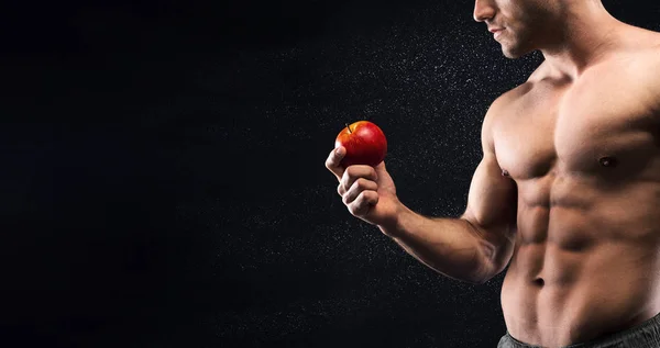 Joven deportivo con hermoso torso sosteniendo manzana roja fresca — Foto de Stock