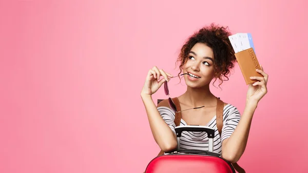 Chica afroamericana soñadora sosteniendo entradas, fondo rosa —  Fotos de Stock