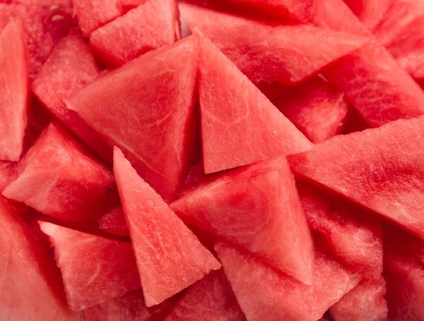 Red watermelon backdrop. Fresh triangle shaped pieces — Stock Photo, Image