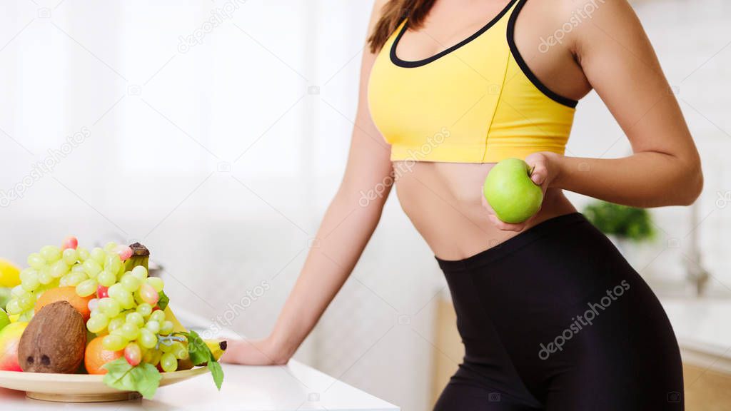 Slim Girl Eating Fruits For Breakfast In Kitchen