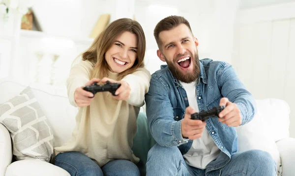 Laughing Couple Playing Video Games By Joysticks