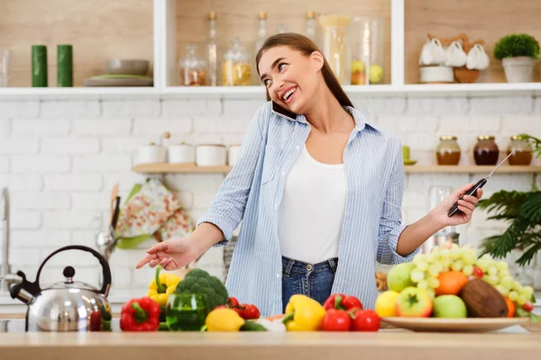 Woman Cooking Salad And Talking On Phone — 스톡 사진