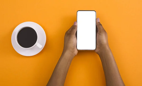 Black woman reading message from blank screen