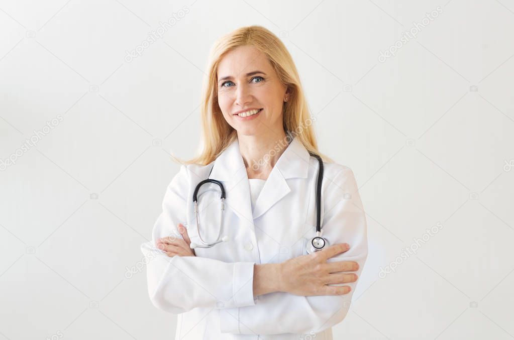 Happy Doctor With Arms Crossed Over Grey Background
