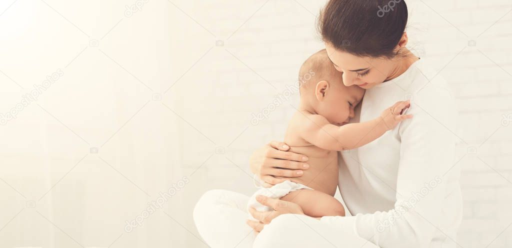 Young mother holding her newborn child in hands