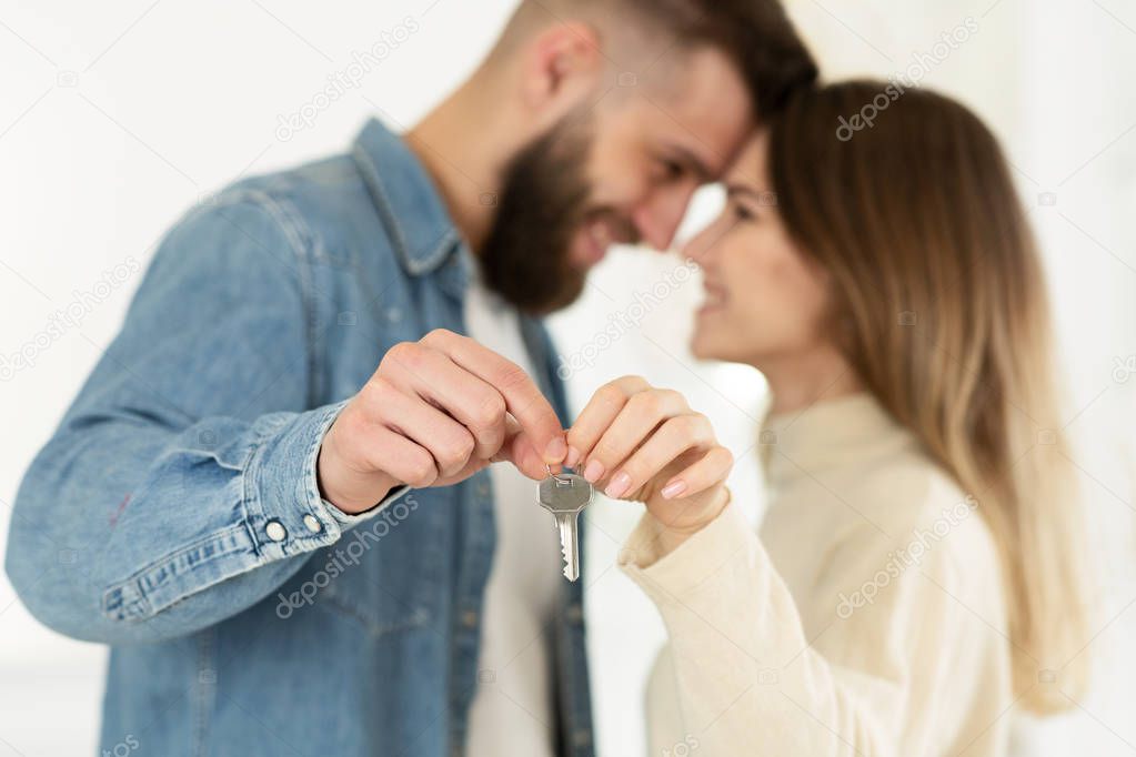 Loving Couple Showing Keys From Their New House