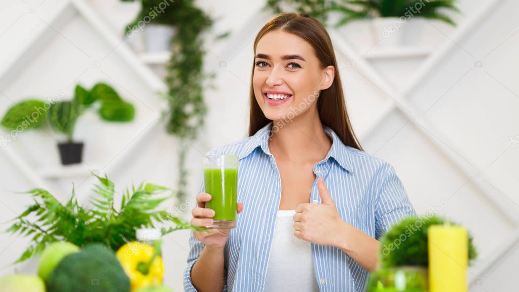 Happy Woman Drinking Smoothie And Showing Thumb Up