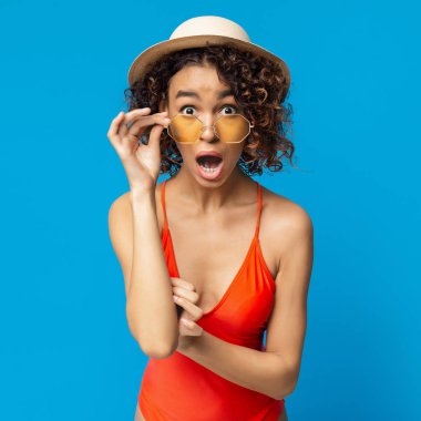 Shocked black girl in swimsuit opened her mouth in amazement clipart