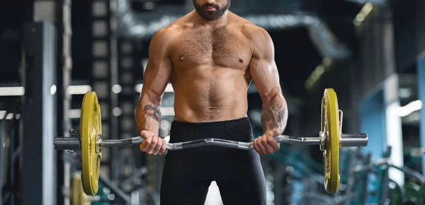 重いバーベルで一生懸命に裸の胴体のトレーニングを持つ筋肉の男 — ストック写真