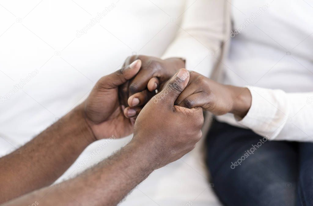 Young black couple holding hands having date