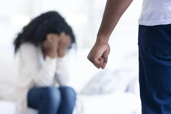 African-american man threatening his scared girlfriend with his fist — Stock Photo, Image