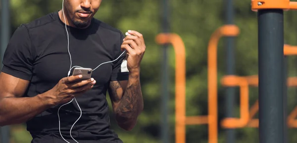 Male Jogger Listening Music Taking Break After Morning Training