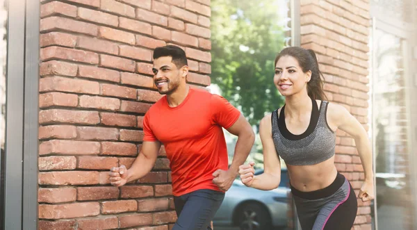 Active couple running every morning in urban