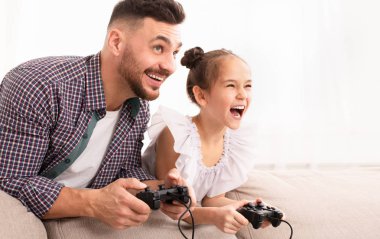 Cheerful dad enjoying video game with his cute daughter